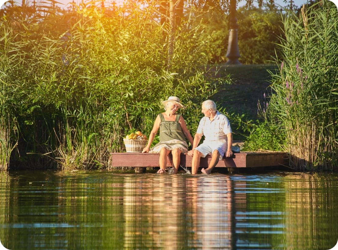 Elderly couple relaxing by a lake after a clinical study