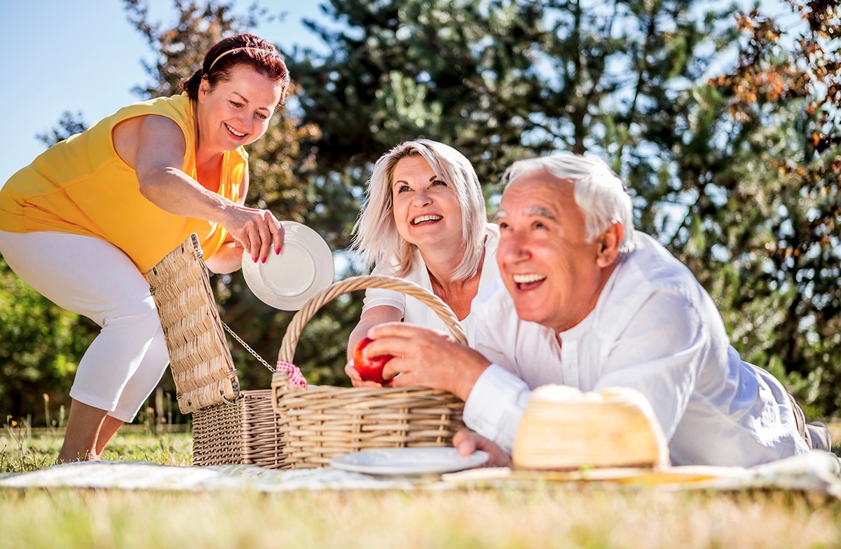 Happy people in picnic after migraine treatment success